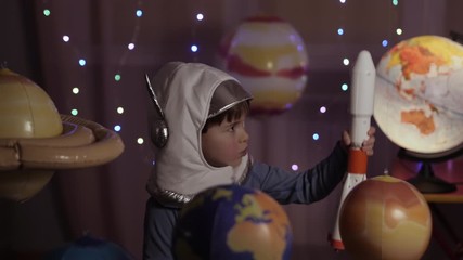 Wall Mural - Space Travel Game Inspiration Spaceship. Little Kid Boy Astronaut Launching Toy Rocket From Spaceport Through Planets. Child Dreamer Playing With Toy Space Rocket Flying Among Planets. SLOW MOTION.