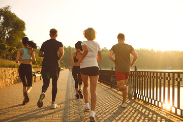 A group of young people are running in the park.