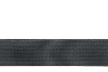 Wide black textile belt. Nothing extra. Belt made of fabric on a white isolated background. The abstraction is interesting. The horizontal location.