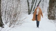 © StockMediaSeller - Stylish woman enjoys a walk in the snowy forest