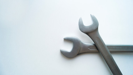 Two steel combination wrenches lie on each other on a white background.  Tools for repair.