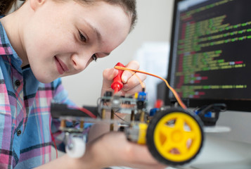 Wall Mural - Female Pupil Building Robotic Car In Science Lesson