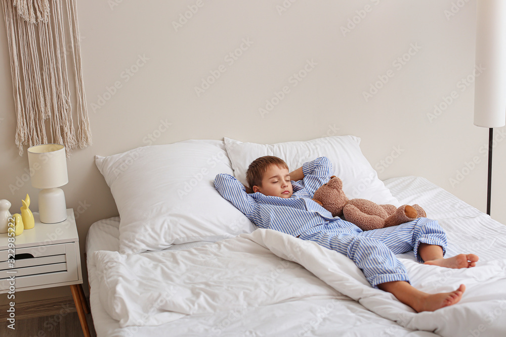 Cute little boy sleeping in bed