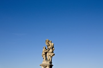 Isolated statue with pigeons in the Charles Bridge (Prague, Czech Republic, Europe)