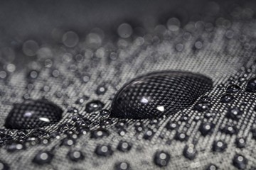 Close-up view on water drop on waterproof impregnated umbrella f