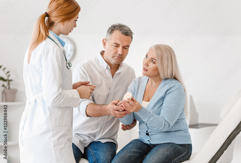 Mature couple visiting doctor in clinic