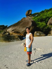 the asian young man standing on the island in Andaman sea in Thailand in the afternoon relaxation and peace 