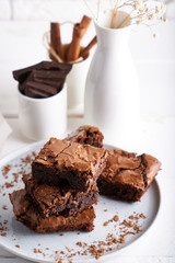 Wall Mural - Pieces of brownie cake served on a white table Chocolate cake