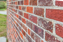 Side Angle View Of Rough Red Brick Textured Exterior Wall