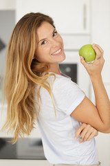 happy woman eating green apple