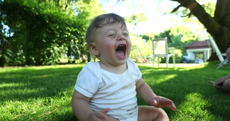 Wall Mural - Angry baby toddler crying in outdoor home garden