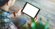 © ouh_desire - Mockup of a man holds tablet computer with isolated screen in his hands. View from above. Clipping path.