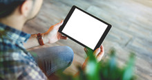 Mockup Of A Man Holds Tablet Computer With Isolated Screen In His Hands. View From Above. Clipping Path.