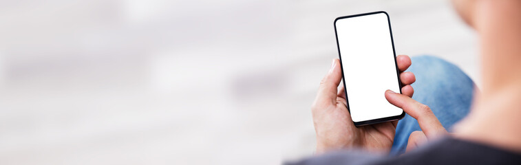 man's hand holding cell phone with blank screen