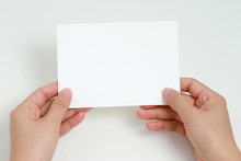 Female Hand Holding Blank White Card For Copy Space