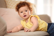 © New Africa - Portrait of cute little child on sofa at home