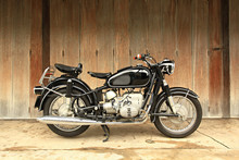 Vintage Motorcycle On Wooden Door Backdrop 