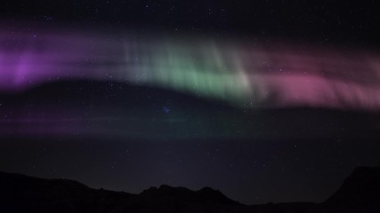 aurora borealis in winter north sky above cliff time lapse simulated northern lights