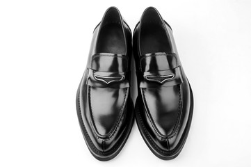 A pair of black men's leather shoes on white