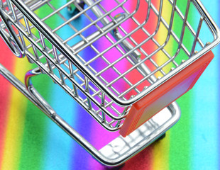 Wall Mural - shopping trolley on colorful background