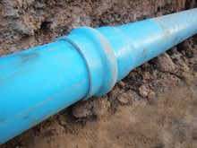 Blue Pvc Pipe Joint Menstrual Plastic Plumbing Pipes With Wear Joints On The Ground Background; Concept Of Water Supply System Maintenance. Selective Focus