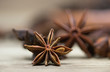 star anise with or without seed, closed, on a light wooden surface. spice for the recipe. beautiful picture, background.
