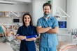 © Тарас Нагирняк - Photo of smiling dentist standing with arms crossed with her colleague.