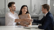 © fizkes - Male broker handshake happy couple congratulate with deal