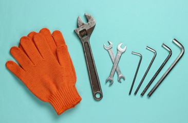 Wall Mural - Set of wrench and gloves on blue background. Work tool. Top view