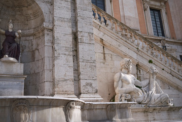 Wall Mural - Rome, Italy - February 03, 2020 : View of the river god Tiber and Minerva statue in front of Palazzo Senatorio