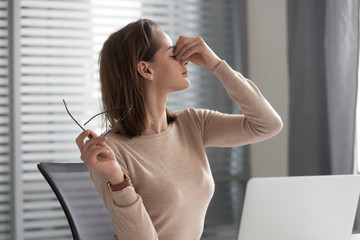 Wall Mural - Tired businesswoman massage eyes suffering from headache