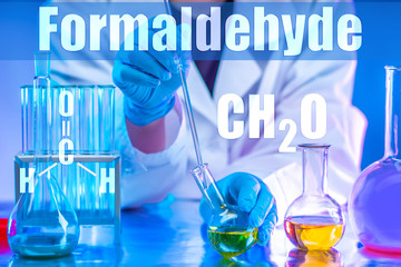 A scientist conducts an experiment in chemistry. Chemical test Chemical laboratory. Scientific research. A man in a white coat. A man with a pipette takes samples.