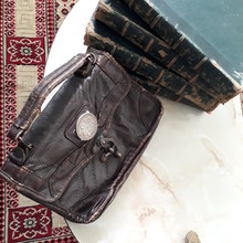 A Very Small Old Leather Handbag With Old  Books