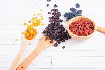 Canvas Print - dried goji, cherry, raisin and plum fruits on white wood