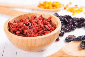 Canvas Print - dried goji, cherry, raisin and plum fruits on white wood