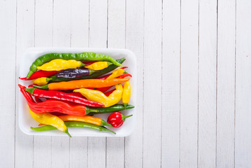 Canvas Print - chili pepper selection on white wood table background