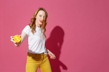 Orange fruits, healthy eating, true emotions - a young blonde woman juggling oranges on pink background - diet, people and mood concept.