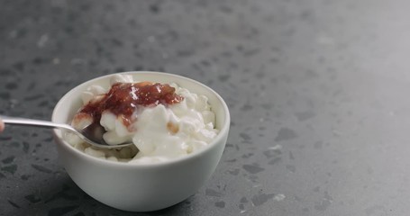 Wall Mural - Slow motion mix fig marmalade with cottage cheese in white bowl on concrete surface