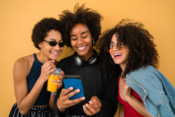 Three Afro friends using mobile phone.