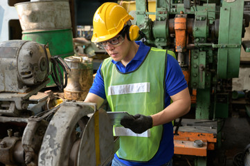 Male asian inspector, engineer working  in the production line process in factory