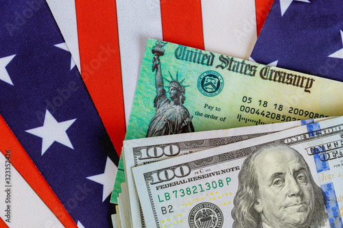Cuadros en Lienzo Stimulus economic tax return check and US 100 dollar bills currency with US flag