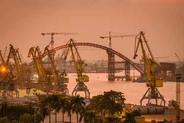 Working field on harbor with cranes and heavy goods to be handled transferred to new destination, northern Vietnam