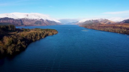 Wall Mural - aerial drone footage of gairlochy near fort william in the argyll region of the highlands of scotland during a clear blue cold winter day with snow on the mountains