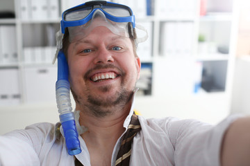 Man wearing suit and tie in goggles and snorkel make selfie with cellphone at office ready to take off portrait. Count days to leave annual day off workaholic freedom fun tourism resort idea concept