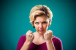 © Aleksej - Angry woman showing fists at camera. People, lifestyle and emotions concept