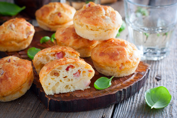 Wall Mural - Muffins with ham and cheese on a wooden board, selective focus