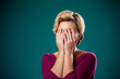 © Aleksej - Sad woman with short blond hair covering her face with hands. Pe