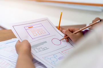 Wall Mural - asian startup designer creating user experience ux web on smartphone or mobile layout development. u