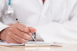 © Joeahead - Hand of a professional doctor with silver pen over the clipboard with medical document going to make notes or prescription.