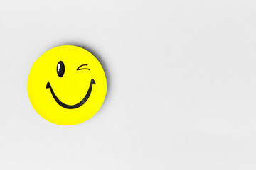 Positive Funny smiley face on a grey cardboard background. Copy space for advertising and texts